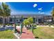 Screened-in patio with outdoor seating overlooks a private pool, surrounded by lush landscaping and serene water views at 15176 Spanish Point Dr, Port Charlotte, FL 33981
