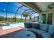 Beautiful screened-in pool and spa with a waterfront view, offering a private outdoor oasis for relaxation and recreation at 15176 Spanish Point Dr, Port Charlotte, FL 33981