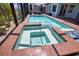 Inviting spa and pool, ideal for relaxing and entertaining in a private outdoor space with lush landscaping at 15176 Spanish Point Dr, Port Charlotte, FL 33981