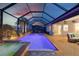 A luxurious pool and spa are framed by a spacious brick patio, perfect for entertaining and enjoying the beautiful sunset views at 15176 Spanish Point Dr, Port Charlotte, FL 33981