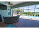Waterfront views from this screened-in lanai with brick flooring and access to the pool, spa, and outdoor grill at 15176 Spanish Point Dr, Port Charlotte, FL 33981