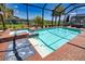 Sparkling pool and spa surrounded by a brick patio, perfect for summer fun and relaxation in a private backyard at 15176 Spanish Point Dr, Port Charlotte, FL 33981