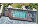 Aerial view of screened pool area featuring a modern outdoor furniture set and brick-paved deck at 15176 Spanish Point Dr, Port Charlotte, FL 33981