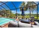 Poolside lounge area with comfortable seating, perfect for enjoying sunny days and relaxing by the sparkling pool and waterfront view at 15176 Spanish Point Dr, Port Charlotte, FL 33981