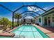 Stunning pool area within screened enclosure, complemented by well-manicured landscaping, providing a serene outdoor living experience at 15176 Spanish Point Dr, Port Charlotte, FL 33981