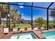 Scenic view of the pool area with a boat dock and waterway, offering a perfect blend of waterfront living and outdoor relaxation at 15176 Spanish Point Dr, Port Charlotte, FL 33981