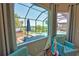 Relaxing view from the home overlooking the pool, spa, outdoor kitchen and waterfront area with boat dock at 15176 Spanish Point Dr, Port Charlotte, FL 33981