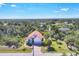 A beautiful aerial view of a single-Gathering home, showing off the roof and surrounding lush greenery at 161 Haddock Dr, Rotonda West, FL 33947