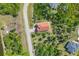 Aerial view shows the property with a well-manicured yard in a private, lush setting at 161 Haddock Dr, Rotonda West, FL 33947