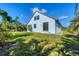 Exterior of the home with a well-maintained yard and tropical landscaping at 161 Haddock Dr, Rotonda West, FL 33947