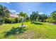 Spacious backyard with a well-maintained lawn and lush tropical landscaping at 161 Haddock Dr, Rotonda West, FL 33947
