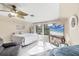 Bright bedroom with a bed, sofa, ceiling fan, large windows, and a television at 161 Haddock Dr, Rotonda West, FL 33947