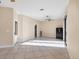 Spacious bonus room has tile floors, a ceiling fan, and access to the backyard via sliding doors at 161 Haddock Dr, Rotonda West, FL 33947
