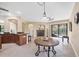 Open dining area with adjacent kitchen, arched doorways, and sliding door access to lanai at 161 Haddock Dr, Rotonda West, FL 33947
