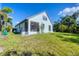 Exterior shot of the property, showing the white facade and expansive backyard at 161 Haddock Dr, Rotonda West, FL 33947