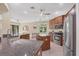 Open kitchen boasts stainless steel appliances, granite countertops, and a central island at 161 Haddock Dr, Rotonda West, FL 33947