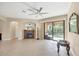 Bright living room with fireplace, ceiling fan, and sliding glass door to the outdoor area at 161 Haddock Dr, Rotonda West, FL 33947