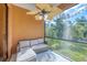 Screened-in patio featuring a comfortable seating area with a ceiling fan and views of the lush yard at 161 Haddock Dr, Rotonda West, FL 33947