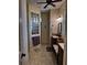 Bathroom featuring light wood-look tile floors, dark cabinets, built in bench seat, and glass block window at 174 Broadmoor Ln, Rotonda West, FL 33947