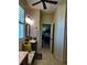 Bathroom featuring light wood-look tile floors, dark cabinets, built in bench seat, and window with blinds at 174 Broadmoor Ln, Rotonda West, FL 33947