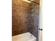 Bathroom bathtub and shower combination featuring neutral colored tile and a white bathtub at 174 Broadmoor Ln, Rotonda West, FL 33947