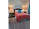 Cozy bedroom with carpet flooring, a queen-sized bed, matching side tables and decorative lamps at 174 Broadmoor Ln, Rotonda West, FL 33947