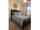 Bedroom with neutral carpet, ceiling fan, and a window covered with patterned curtains at 174 Broadmoor Ln, Rotonda West, FL 33947