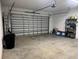 A spacious garage with a large door, concrete floor, and ample room for storage at 174 Broadmoor Ln, Rotonda West, FL 33947