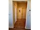 Neutral colored hallway with tile floors, showing three closed doors and a thermostat on the wall at 174 Broadmoor Ln, Rotonda West, FL 33947