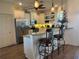 Modern kitchen with granite counters, stainless steel appliances, and breakfast bar with seating at 174 Broadmoor Ln, Rotonda West, FL 33947