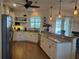 Well-lit kitchen featuring granite counters, stainless steel appliances, and ample cabinet space at 174 Broadmoor Ln, Rotonda West, FL 33947