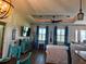Open-concept living room featuring wood floors, stylish decor, tray ceiling and plenty of natural light at 174 Broadmoor Ln, Rotonda West, FL 33947