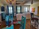 Open-concept living room and dining area featuring wood floors, stylish decor and plenty of natural light at 174 Broadmoor Ln, Rotonda West, FL 33947
