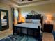Comfortable main bedroom with tray ceiling, a king bed, and carpet at 174 Broadmoor Ln, Rotonda West, FL 33947
