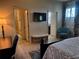 Main bedroom with a view of walk-in closets, a TV, and bathroom entrance at 174 Broadmoor Ln, Rotonda West, FL 33947
