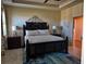 Comfortable main bedroom with tray ceiling, a king bed, and carpet at 174 Broadmoor Ln, Rotonda West, FL 33947