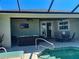 Inviting covered patio with a ceiling fan, outdoor seating, and a view of the sparkling pool at 174 Broadmoor Ln, Rotonda West, FL 33947
