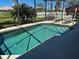 Sparkling pool with a screened enclosure, lush landscaping and a sunny pool deck at 174 Broadmoor Ln, Rotonda West, FL 33947