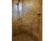 Shower stall featuring neutral-colored tile and a built-in bench seat with a showerhead at 174 Broadmoor Ln, Rotonda West, FL 33947