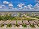 Stunning aerial view of a community featuring lush landscaping, serene lake views, and well-maintained homes under a clear blue sky at 1836 W Isles Rd, Port Charlotte, FL 33953