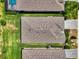 Overhead view of home's roof highlighting its design and features, with adjacent lawn and community layout at 1836 W Isles Rd, Port Charlotte, FL 33953