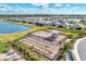 Aerial view of the community playground near new homes and a tranquil lake at 1836 W Isles Rd, Port Charlotte, FL 33953