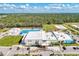 Community center showcasing a pool, playground, and recreational field against a lush, forested backdrop at 1836 W Isles Rd, Port Charlotte, FL 33953