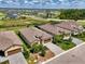 This aerial view highlights the home's position, landscaping, and neighboring houses within the community at 1836 W Isles Rd, Port Charlotte, FL 33953