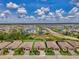 Stunning aerial view of a community featuring lush landscaping, serene lake views, and well-maintained homes under a clear blue sky at 1836 W Isles Rd, Port Charlotte, FL 33953