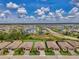 Stunning aerial view of a community featuring lush landscaping, serene lake views, and well-maintained homes under a clear blue sky at 1836 W Isles Rd, Port Charlotte, FL 33953