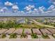 Stunning aerial view of a community featuring lush landscaping, serene lake views, and well-maintained homes under a clear blue sky at 1836 W Isles Rd, Port Charlotte, FL 33953