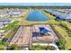 Aerial shot of the community playground alongside a serene lake and neighborhood homes at 1836 W Isles Rd, Port Charlotte, FL 33953