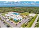 Aerial view of a community center with a pool, playground, and parking area at 1836 W Isles Rd, Port Charlotte, FL 33953