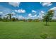 Lush green backyard offers plenty of space, complemented by a well-maintained lawn and mature trees at 1836 W Isles Rd, Port Charlotte, FL 33953